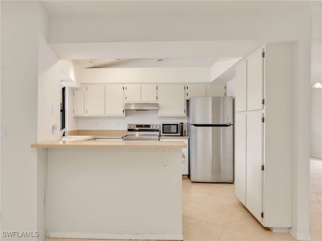 kitchen featuring appliances with stainless steel finishes, kitchen peninsula, sink, and light tile patterned floors