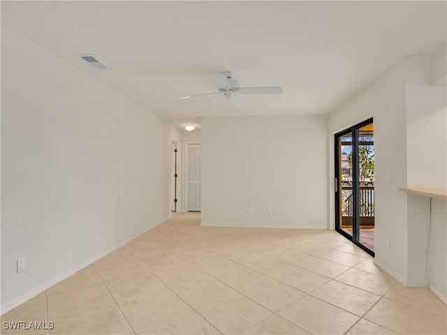 empty room featuring light tile patterned floors and ceiling fan