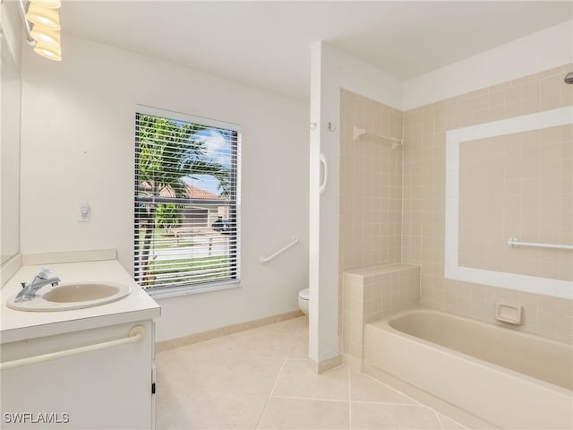 full bathroom featuring tile patterned flooring, vanity, tiled shower / bath combo, and toilet