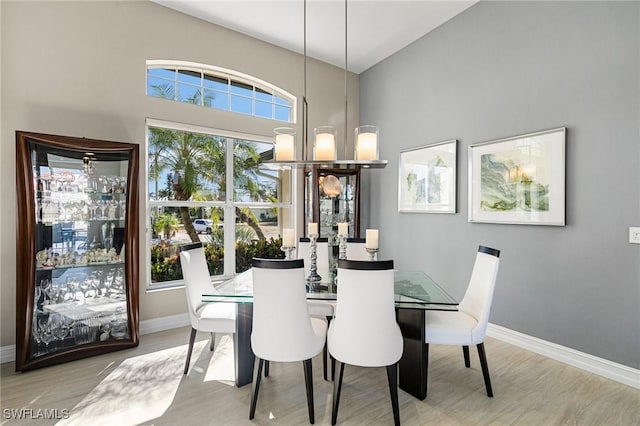 dining space with a notable chandelier and light wood-type flooring