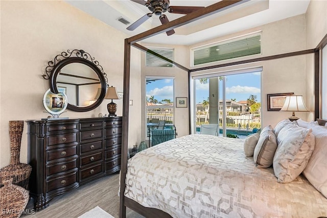 bedroom with access to exterior, light hardwood / wood-style flooring, and ceiling fan