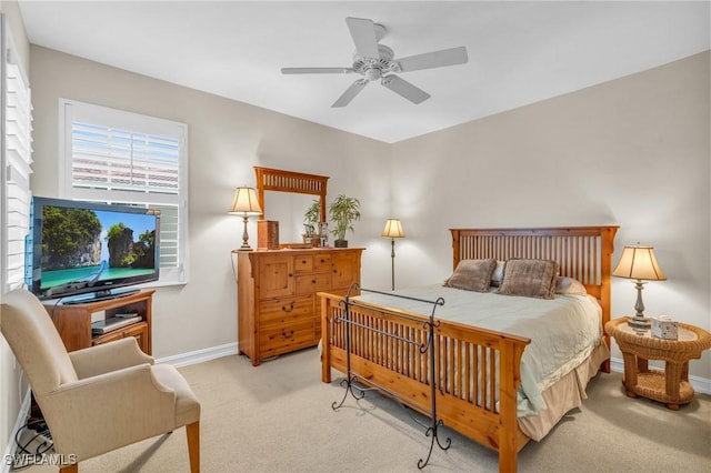 bedroom featuring ceiling fan and light carpet