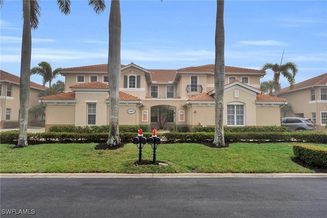 mediterranean / spanish-style home featuring a front lawn