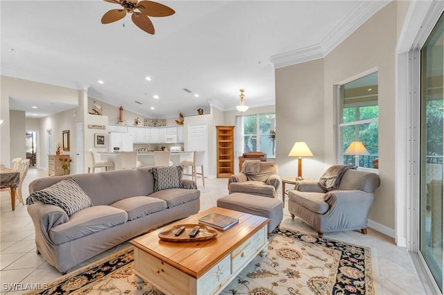 living room with light tile patterned floors, ceiling fan, and ornamental molding