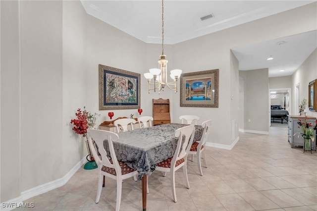 tiled dining space with a chandelier