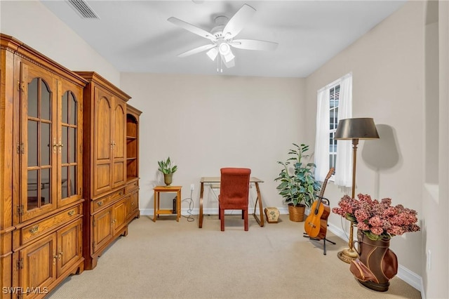 living area featuring ceiling fan and light colored carpet