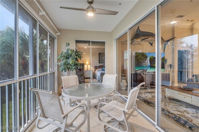 sunroom / solarium featuring ceiling fan