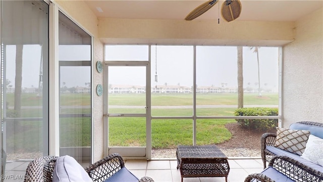 sunroom featuring ceiling fan