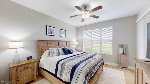 bedroom with ceiling fan and light hardwood / wood-style floors