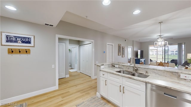 kitchen with light wood-type flooring, stainless steel dishwasher, ceiling fan, sink, and white cabinetry