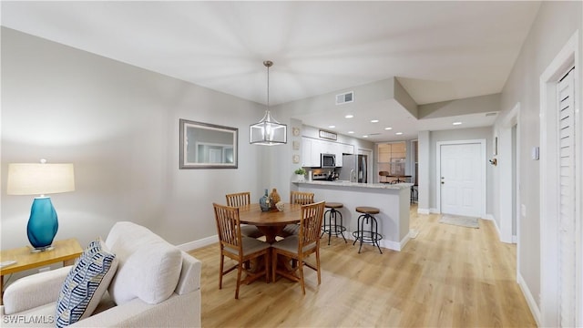 dining room featuring a chandelier and light hardwood / wood-style floors