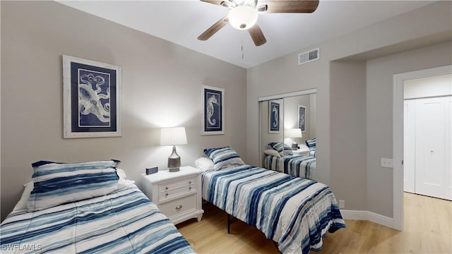 bedroom with a closet, ceiling fan, and light hardwood / wood-style flooring