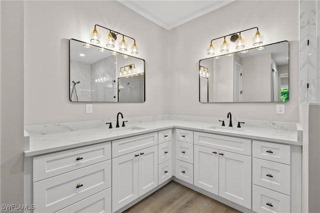 bathroom with vanity, wood-type flooring, and walk in shower