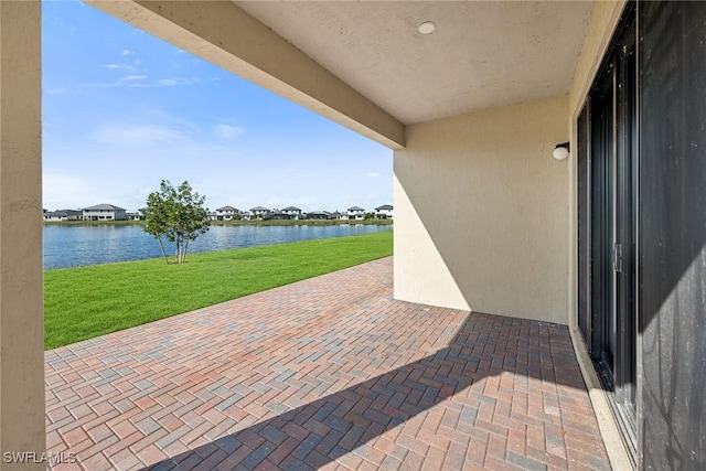 view of patio with a water view