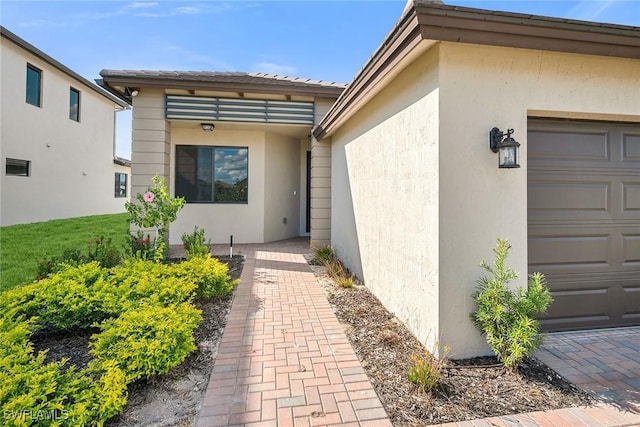 view of exterior entry with a garage