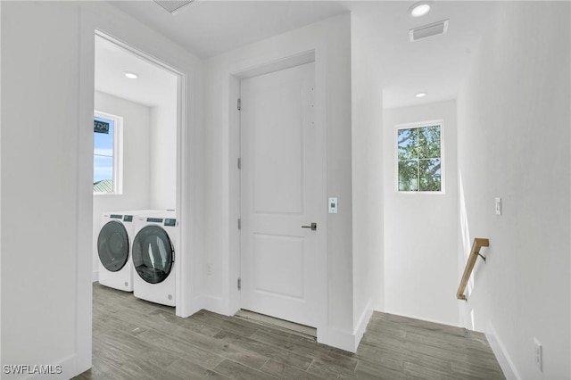 3190 Shell Mound Blvd, Fort Myers Beach, FL 33931 - clothes washing area featuring washer and clothes dryer, baseboards, visible vents, and wood finished floors