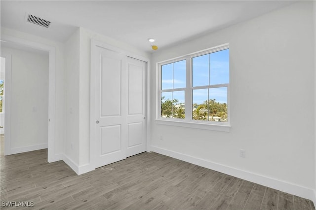 3190 Shell Mound Blvd, Fort Myers Beach, FL 33931 - unfurnished bedroom with baseboards, multiple windows, visible vents, and wood finished floors