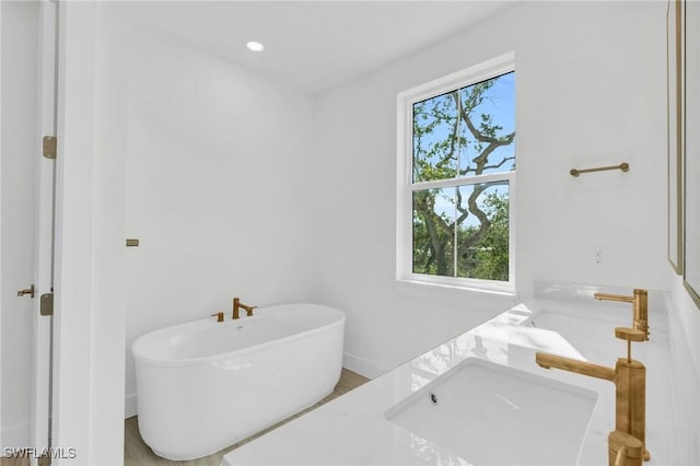 3190 Shell Mound Blvd, Fort Myers Beach, FL 33931 - full bathroom with vanity, baseboards, and a freestanding tub