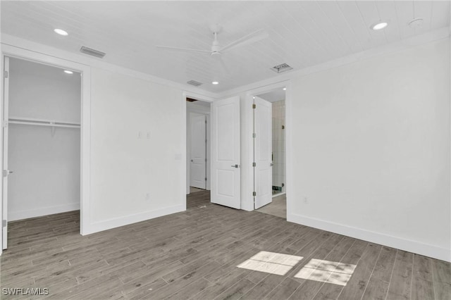 unfurnished bedroom with ceiling fan, a closet, and wood-type flooring