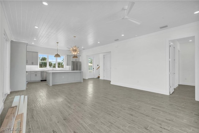 unfurnished living room with light wood-type flooring, crown molding, and ceiling fan