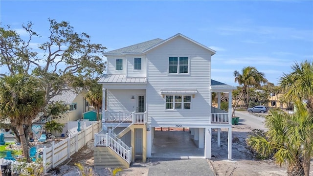 view of front of home featuring a porch and a carport