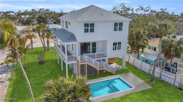 back of house with a lawn, a patio, and a fenced in pool