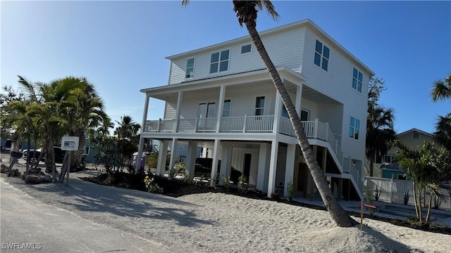 coastal home featuring stairway and a porch