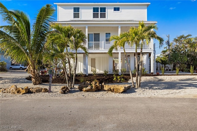 3190 Shell Mound Blvd, Fort Myers Beach, FL 33931 - coastal inspired home with covered porch, driveway, and a balcony