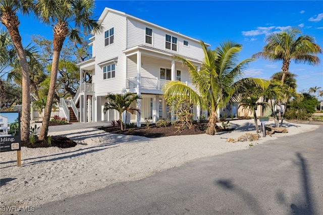 3190 Shell Mound Blvd, Fort Myers Beach, FL 33931 - coastal home with covered porch, driveway, and stairs
