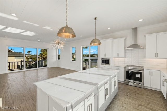 3190 Shell Mound Blvd, Fort Myers Beach, FL 33931 - kitchen featuring stainless steel range with electric stovetop, a healthy amount of sunlight, a center island, and wall chimney exhaust hood