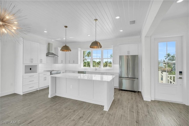 3190 Shell Mound Blvd, Fort Myers Beach, FL 33931 - kitchen featuring stainless steel appliances, visible vents, wall chimney range hood, a kitchen island, and recessed lighting