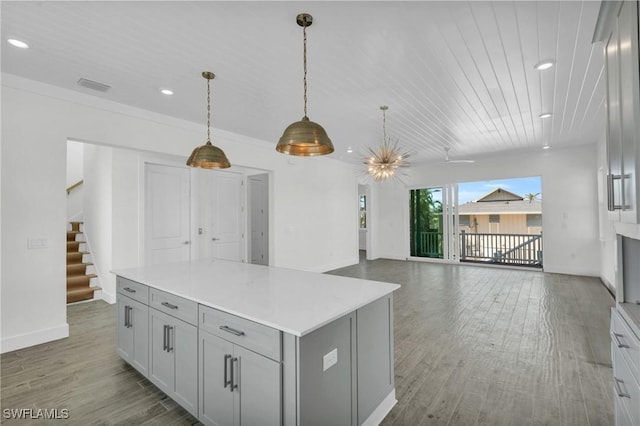 3190 Shell Mound Blvd, Fort Myers Beach, FL 33931 - kitchen with wood finished floors, gray cabinets, baseboards, visible vents, and recessed lighting
