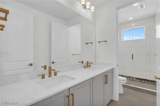 3190 Shell Mound Blvd, Fort Myers Beach, FL 33931 - bathroom featuring double vanity, toilet, visible vents, and a sink
