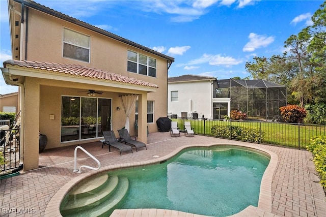 rear view of house with a fenced in pool, ceiling fan, and a patio