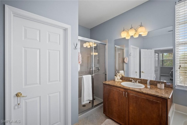 bathroom featuring tile patterned floors, vanity, and a shower with shower door