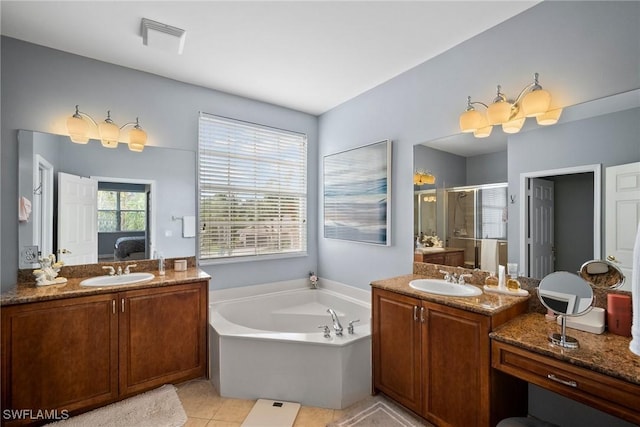 bathroom featuring tile patterned flooring, vanity, and shower with separate bathtub