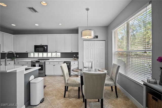 kitchen with pendant lighting, stainless steel electric range, wine cooler, light tile patterned floors, and white cabinetry