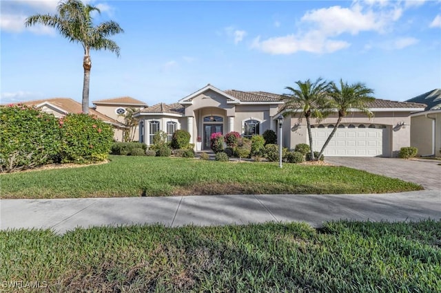 view of front of property with a garage and a front lawn