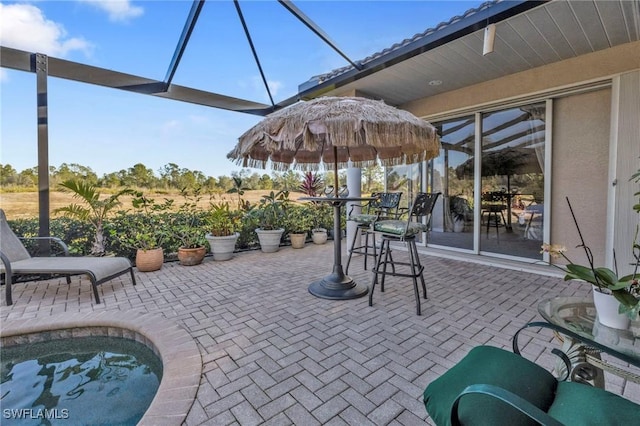 view of patio featuring glass enclosure