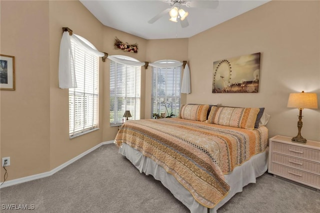 bedroom featuring ceiling fan, light carpet, and multiple windows