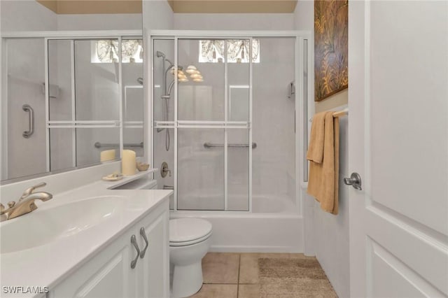 full bathroom with tile patterned flooring, vanity, toilet, and bath / shower combo with glass door