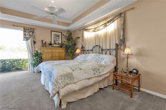 carpeted bedroom with ceiling fan, access to outside, and a tray ceiling