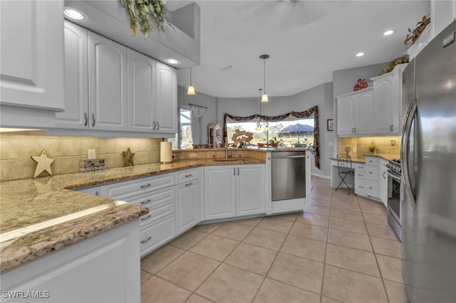 kitchen featuring kitchen peninsula, white cabinetry, pendant lighting, and appliances with stainless steel finishes