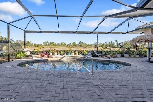 view of swimming pool featuring a patio and glass enclosure