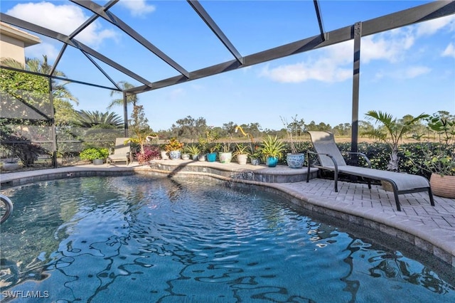 view of swimming pool featuring a lanai and a patio area