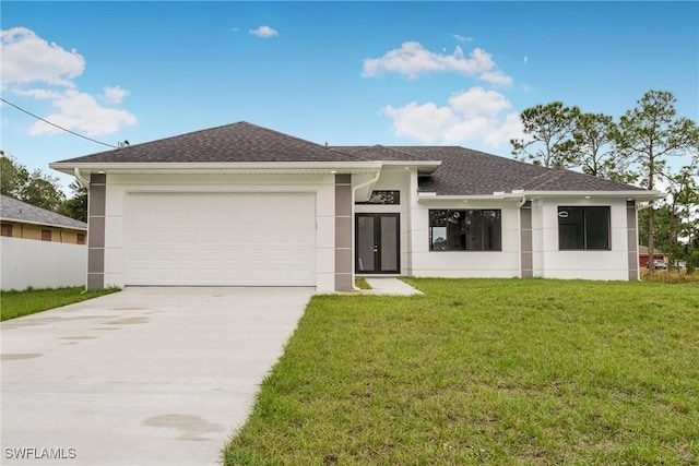 view of front of home with a garage and a front yard