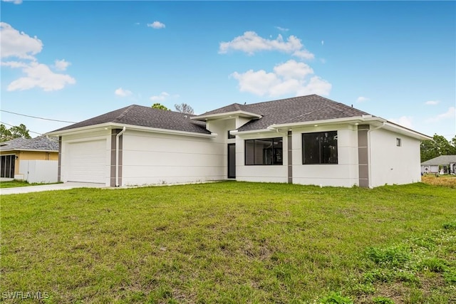 view of front of house featuring a garage and a front lawn