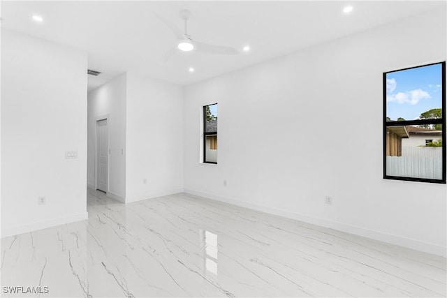 empty room featuring plenty of natural light and ceiling fan