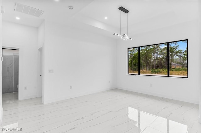 empty room featuring a raised ceiling