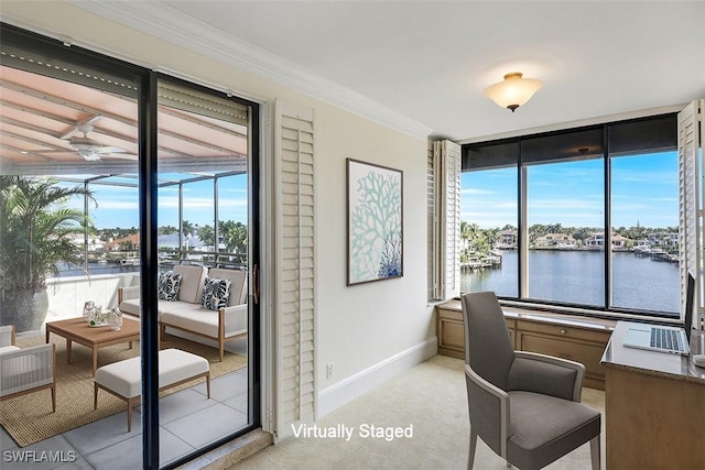 office space featuring ceiling fan, light carpet, a water view, baseboards, and ornamental molding